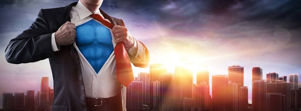 A businessman opening his shirt to reveal a blue superhero costume, a city skyline at sunset behind