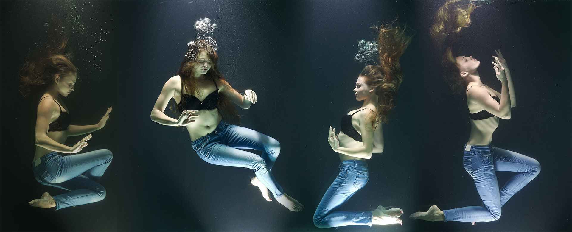 A woman in jeans suspended underwater in a sequence of four poses, bubbles rising around her